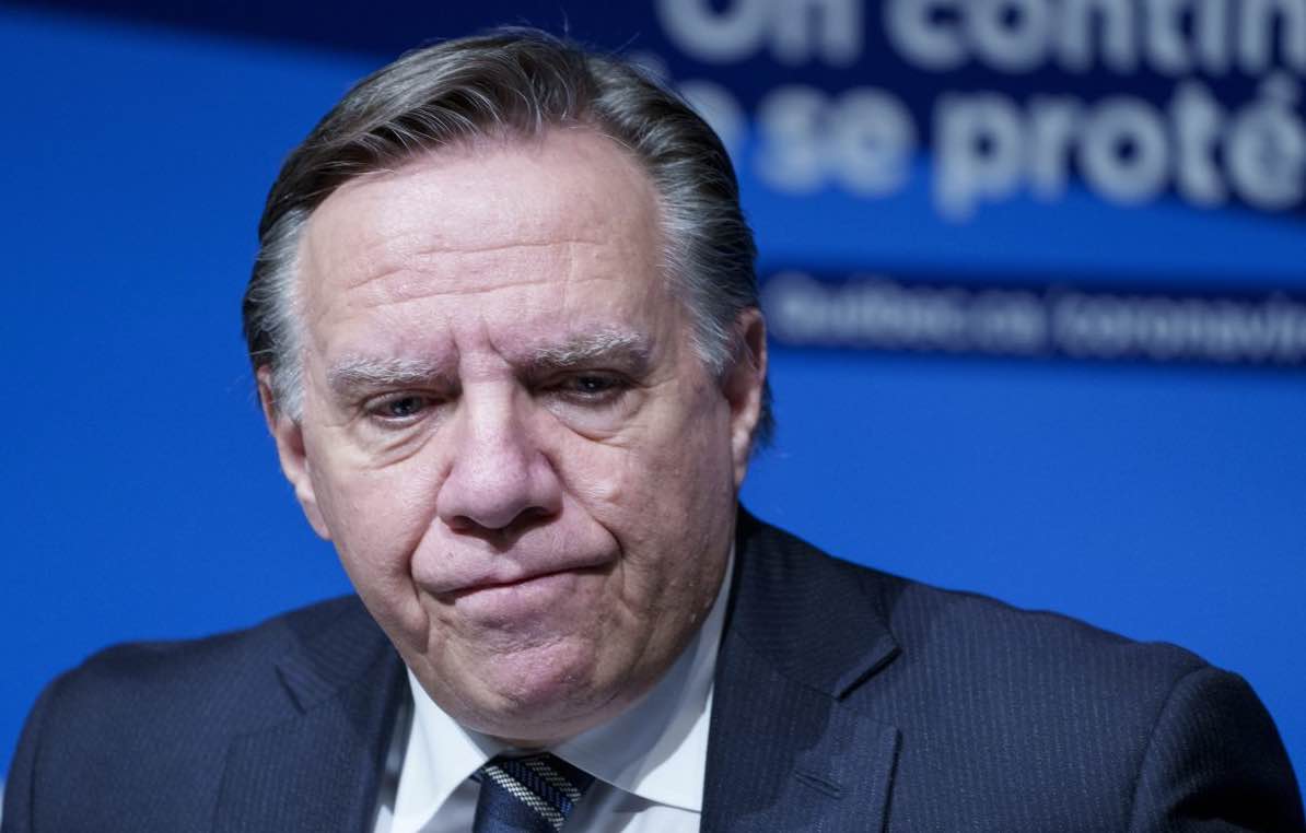 Quebec Premier Francois Legault listens to a question during a news conference in Montreal, on Thursday, December 16, 2021