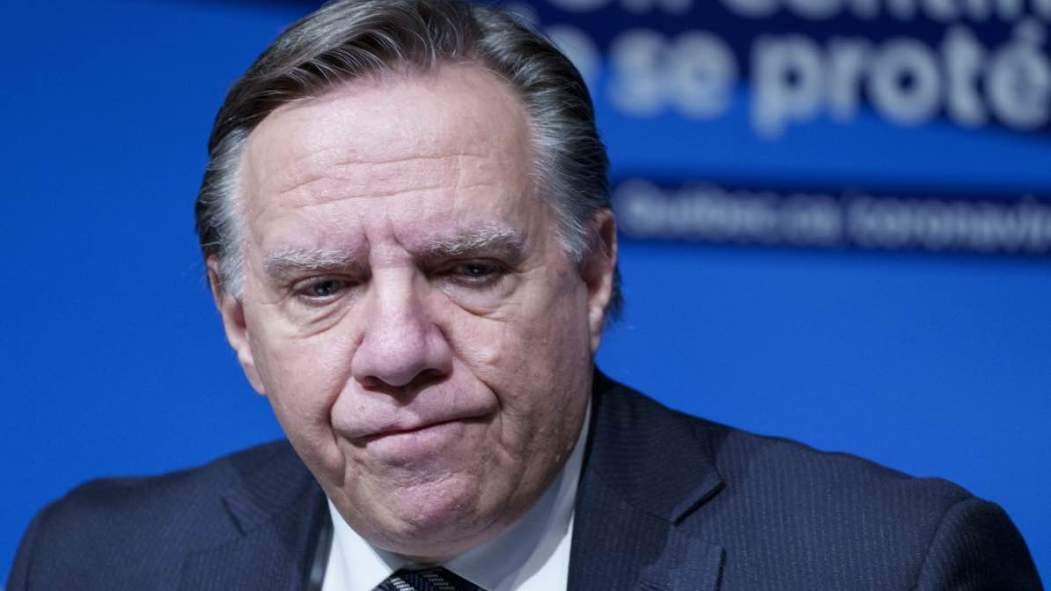 Quebec Premier Francois Legault listens to a question during a news conference in Montreal, on Thursday, December 16, 2021