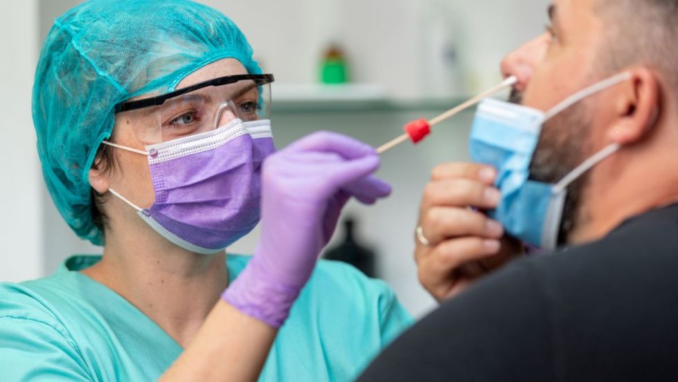 Un membre du personnel de la santé teste un patient pour la COVID-19.